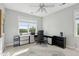 Well-lit home office featuring neutral colors, large windows, and built-in storage solutions at 591 Island Walk East, Mount Pleasant, SC 29464