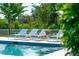 Relaxing poolside view featuring comfortable lounge chairs and vibrant green foliage around the pool area at 591 Island Walk East, Mount Pleasant, SC 29464