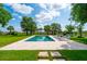 Relaxing pool area with travertine tile, chaise lounges and lush greenery provides a private outdoor oasis at 591 Island Walk East, Mount Pleasant, SC 29464