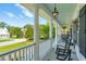 Spacious front porch with rocking chairs, offering a relaxing outdoor space with neighborhood views at 591 Island Walk East, Mount Pleasant, SC 29464