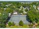 Aerial view of the community tennis courts surrounded by lush greenery and neighborhood at 591 Island Walk East, Mount Pleasant, SC 29464