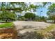 Outdoor sand volleyball court surrounded by mature trees and lush landscaping on a sunny day at 591 Island Walk East, Mount Pleasant, SC 29464