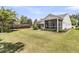 Spacious backyard with lush green lawn, mature trees, and a screened porch for outdoor enjoyment at 602 Eastern Isle Ave, Summerville, SC 29486