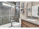 Tiled shower and granite-topped vanity in updated bathroom at 602 Eastern Isle Ave, Summerville, SC 29486