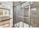 Modern tiled shower with glass doors and updated fixtures adjacent to primary bedroom at 602 Eastern Isle Ave, Summerville, SC 29486