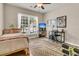 Cozy bedroom with natural light, ceiling fan, and a dedicated workspace at 602 Eastern Isle Ave, Summerville, SC 29486