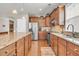 Well-appointed kitchen with granite counters, stainless steel appliances, wooden cabinetry and hardwood flooring at 602 Eastern Isle Ave, Summerville, SC 29486