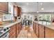 Spacious kitchen with granite countertops, wooden cabinets, stainless steel appliances, and hardwood flooring at 602 Eastern Isle Ave, Summerville, SC 29486