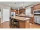 Kitchen island with dark wood cabinets, granite counters, and modern appliances at 602 Eastern Isle Ave, Summerville, SC 29486