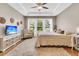 Main bedroom with ceiling fan, sitting area, plush carpet, and a large window overlooking the yard at 602 Eastern Isle Ave, Summerville, SC 29486