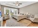 Spacious main bedroom with a tray ceiling, large window and sitting area at 602 Eastern Isle Ave, Summerville, SC 29486
