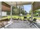 Screened-in porch with comfortable seating and a serene view of the backyard pond at 602 Eastern Isle Ave, Summerville, SC 29486