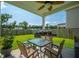 View of covered back patio with ceiling fan, outdoor seating, BBQ grill, and manicured lawn at 602 Jancus St, Charleston, SC 29414