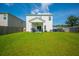 Large backyard with rear house facade, covered patio, privacy fence, and lush green lawn at 602 Jancus St, Charleston, SC 29414