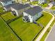 An aerial shot of a spacious fenced backyard featuring a lush green lawn and a covered patio area at 602 Jancus St, Charleston, SC 29414