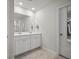 Well-lit bathroom with a double sink vanity, neutral tile flooring, and a partially visible walk-in shower at 602 Jancus St, Charleston, SC 29414