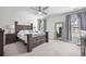 This bedroom boasts a wooden bed frame, ceiling fan, and a decorative mirror with an elegant design at 602 Jancus St, Charleston, SC 29414