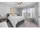 Bright bedroom with a cozy bed, ceiling fan, and large window offering natural light and neighborhood views at 602 Jancus St, Charleston, SC 29414