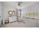 Charming Bedroom showcasing a floral wallpaper accent wall, white dresser, and a cozy rocking chair at 602 Jancus St, Charleston, SC 29414