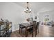 Bright dining area features a dark wood table, seating for four, a chandelier and wood-look floors at 602 Jancus St, Charleston, SC 29414