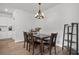 Cozy dining area featuring a dark wood table, four chairs, a chandelier, and wood-look flooring at 602 Jancus St, Charleston, SC 29414