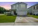 Charming two-story home with well-manicured lawn, black front door, and attached garage at 602 Jancus St, Charleston, SC 29414