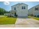 Inviting two-story home features a manicured lawn, a classic front porch, and an attached two-car garage at 602 Jancus St, Charleston, SC 29414