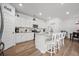 Eat-in kitchen featuring white cabinets, granite countertops, stainless steel appliances, and seating at the island at 602 Jancus St, Charleston, SC 29414