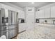 Bright kitchen with white cabinets, stainless steel appliances, granite countertops and an 'eat' sign at 602 Jancus St, Charleston, SC 29414