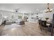 Open-concept living space with a sectional sofa, kitchen with island, and dining area with wood table at 602 Jancus St, Charleston, SC 29414