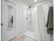 Modern shower area with white tiles, a sleek shower head, and a glass door entrance at 602 Jancus St, Charleston, SC 29414