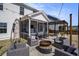 Inviting backyard patio with screened porch, pergola, fire pit, and comfortable outdoor seating at 624 Sienna Way, Summerville, SC 29486