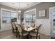 Bright dining room featuring a wood table, six chairs, wainscoting and a modern chandelier at 624 Sienna Way, Summerville, SC 29486