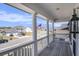 Spacious front porch with white columns and railings overlooking a street with an American flag at 624 Sienna Way, Summerville, SC 29486