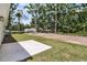 Backyard with green grass, trees, and a concrete patio at 6513 Highway 162, Hollywood, SC 29449