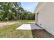 Backyard view with green grass, trees, and a concrete patio at 6513 Highway 162, Hollywood, SC 29449