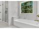 Bathroom featuring a shower with glass door, marble countertops, sleek gold faucets, and a bright window at 6513 Highway 162, Hollywood, SC 29449
