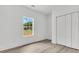 Bright bedroom with wood flooring, a window with a view of the outdoors, and a closet with bi-fold doors at 6513 Highway 162, Hollywood, SC 29449