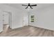 Bright bedroom features modern ceiling fan, trim, and light wood flooring with doors to bath and closet at 6513 Highway 162, Hollywood, SC 29449