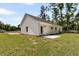 Exterior of home with green grass, trees, and concrete patio at 6513 Highway 162, Hollywood, SC 29449