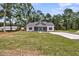 A full view of the house including the wide open green front yard and a long driveway to the side at 6513 Highway 162, Hollywood, SC 29449