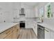 Bright kitchen featuring stainless steel appliances, white cabinets, and a large island at 6513 Highway 162, Hollywood, SC 29449