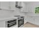 Modern kitchen featuring white cabinets, quartz countertops, and stainless steel appliances at 6513 Highway 162, Hollywood, SC 29449