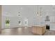 Open-concept living and kitchen with a center island and stainless appliances and a view of the front yard at 6513 Highway 162, Hollywood, SC 29449