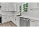 Kitchen features white cabinets, gold hardware, subway tile backsplash, and stainless steel appliances at 6513 Highway 162, Hollywood, SC 29449