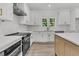 Well-appointed kitchen with white cabinets, quartz countertops, and stainless steel appliances at 6513 Highway 162, Hollywood, SC 29449