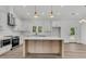 Bright kitchen with white cabinets, stainless steel appliances, and large island at 6513 Highway 162, Hollywood, SC 29449