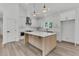 Bright kitchen with white cabinets, stainless steel appliances, and large island at 6513 Highway 162, Hollywood, SC 29449