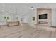 Open-concept living room and kitchen area with vaulted ceilings, modern fireplace, and wood-look flooring at 6513 Highway 162, Hollywood, SC 29449