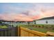 Large, fenced backyard with a pond view and minimal plantings from a wooden deck at 701 Squire Pope Rd, Summerville, SC 29486